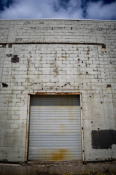 istock Industrial white brick wall with rusted garage 2223832950