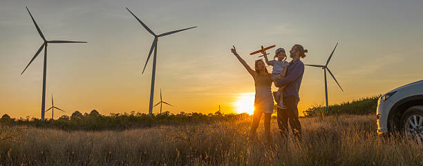istock Family with son walking on field on wind farm 2223835055