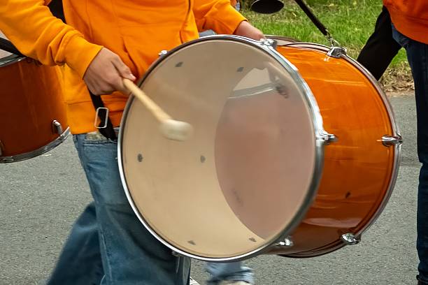 Musician playing marching bass drum during parade