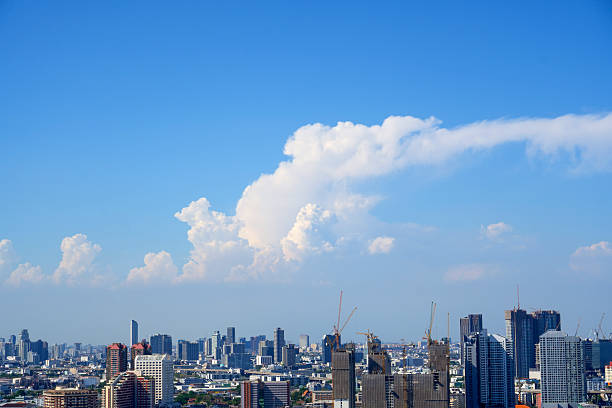 Cumulonimbus cloud over big city skyline view.