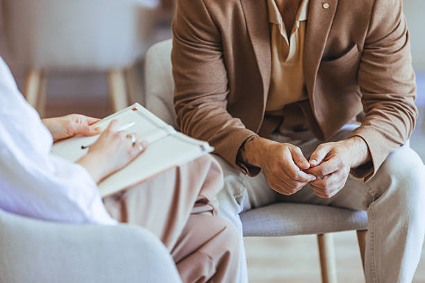 Therapist Counseling Session with Male Client in a Bright Office Setting