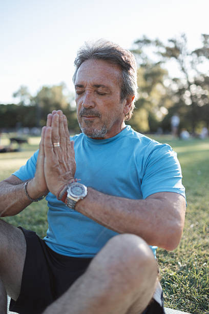 istock Mature man meditating in a park, finding inner peace and serenity 2223837950