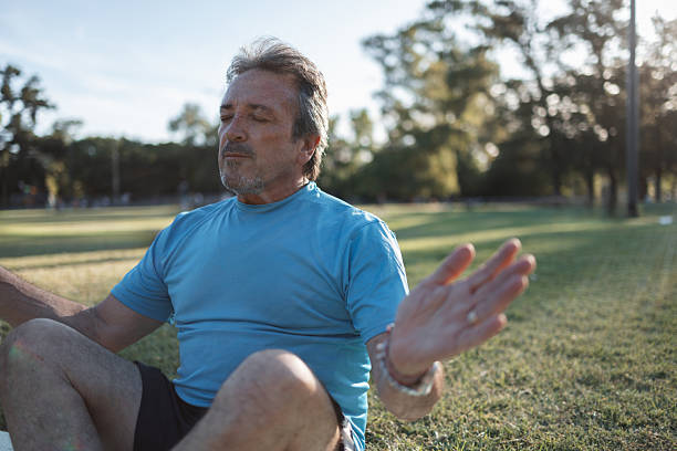 istock Mature man practicing yoga and meditation in a public park 2223837958