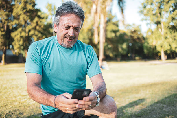 istock Senior man checking his smart phone after exercising in the park 2223837975