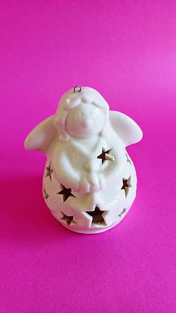 istock White ceramic Angel figurine on pink background 2223838856