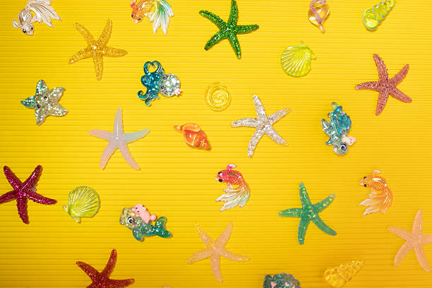 Starfish, fish and seashells on a yellow background. Children's game concept