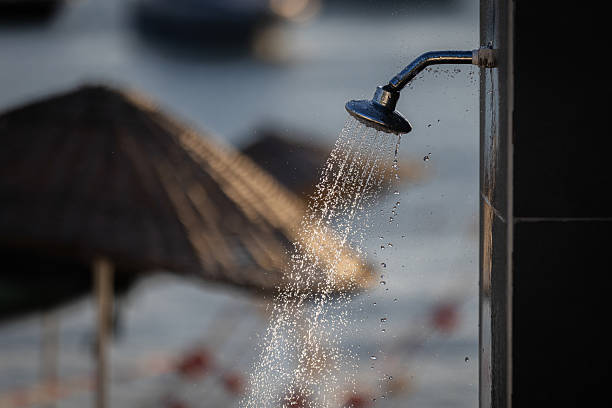 Summer beach view.\nShower with blurry beach background.
