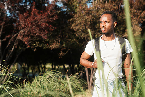 istock young man walking in nature 2223849840