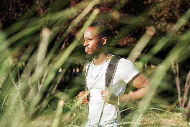 istock young man walking in nature 2223850422