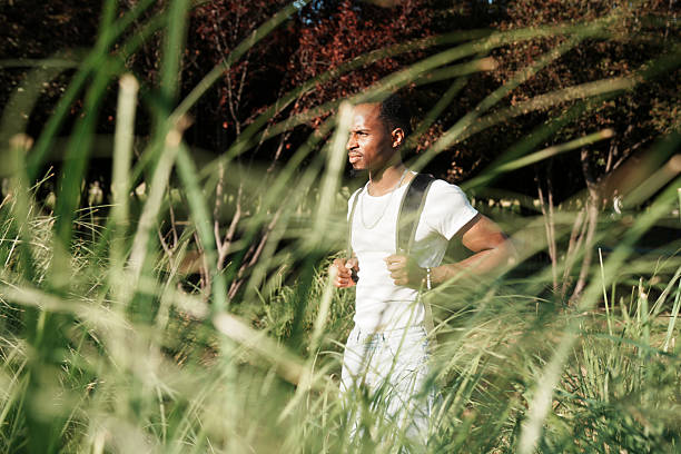 istock young man walking in nature 2223850424