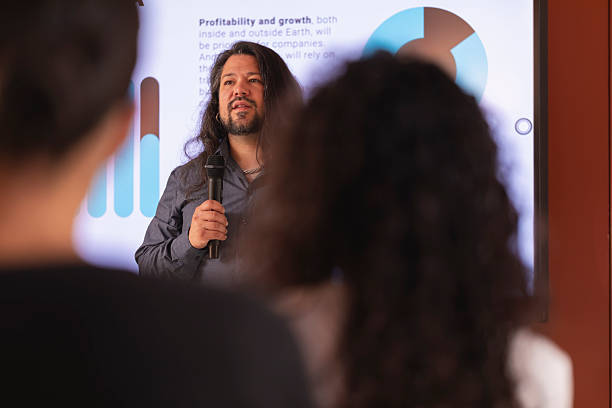 istock A man with long hair shows a report with data, during a colloquium talk in the office 2223851159