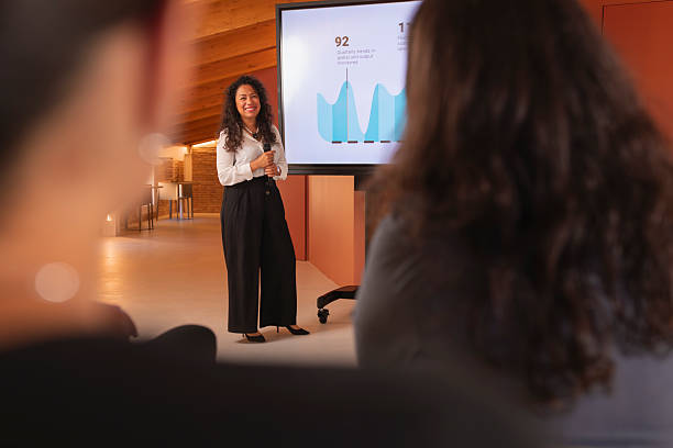 istock A woman with Latin features shows a report with data, during a colloquium talk in the office 2223852837
