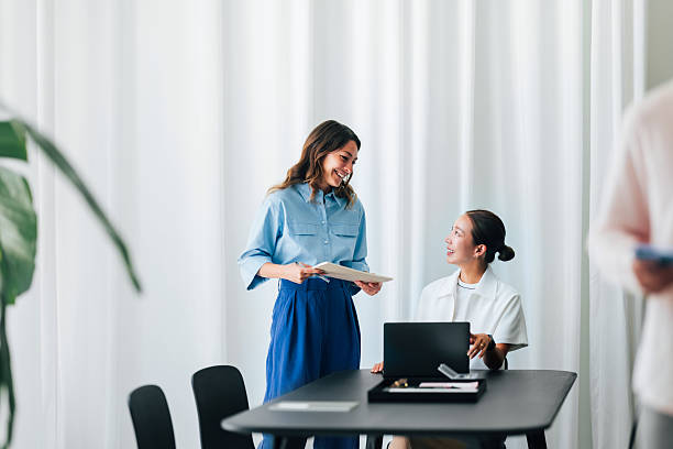 istock Professional Colleagues Engaging in Office Collaboration at a Modern Workplace 2223853406