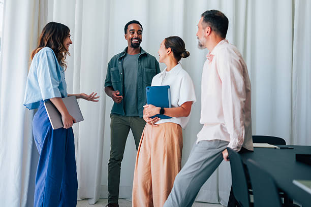 istock Professional Colleagues Engaged in a Friendly Discussion in Modern Office Setting 2223853409