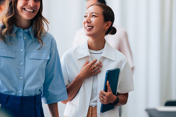 istock Smiling Women Enjoy a Casual Conversation in a Professional Setting 2223853414
