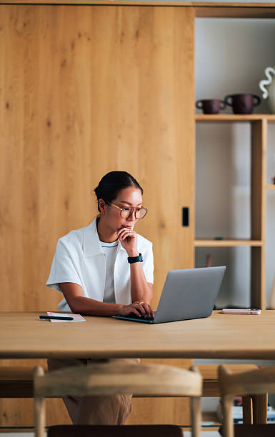Focused Businesswoman Working on Laptop in Modern Office Environment