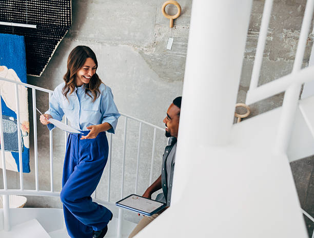 Casual Business Colleagues Interacting on a Modern Spiral Staircase