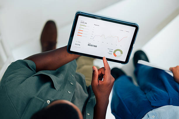 istock Business Professionals Collaborating Over Data on a Digital Tablet in an Office Setting 2223853444