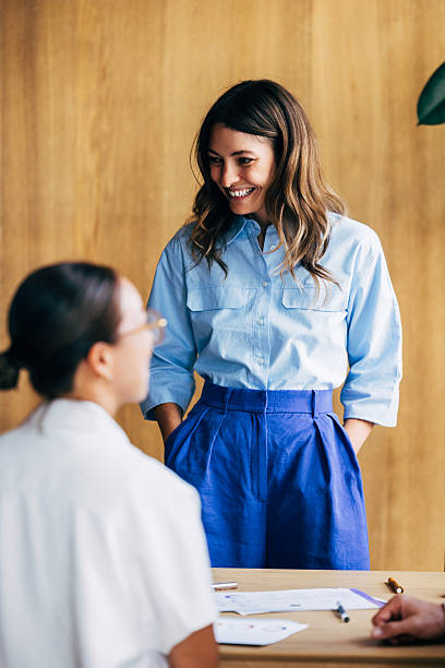 Smiling Colleagues Interacting During a Team Meeting in a Professional Office Setting