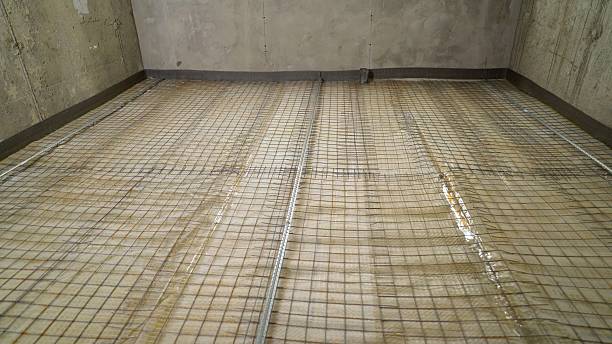 istock Waterproofing membrane and reinforcing mesh being installed on concrete floor 2223855090