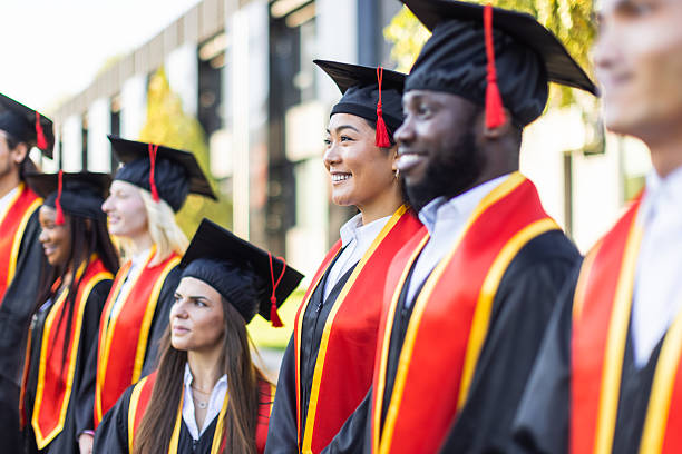 istock Graduation Day: Happy Graduates in Caps and Gowns 2223855908