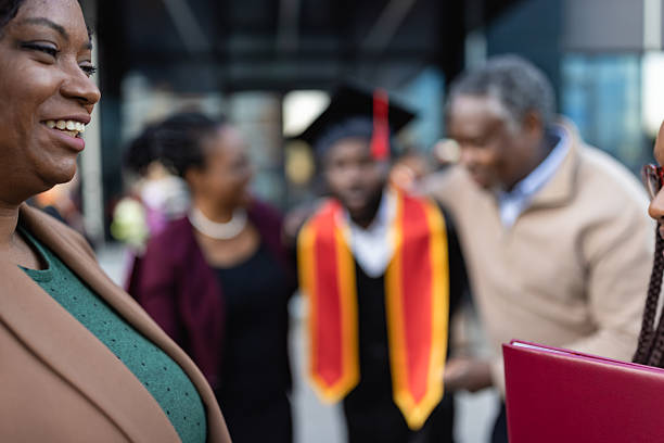 Single college graduate in gown holding hire me sign