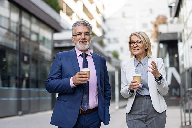 istock Cheerful Executives Enjoying Coffee and Company Outside 2223858260