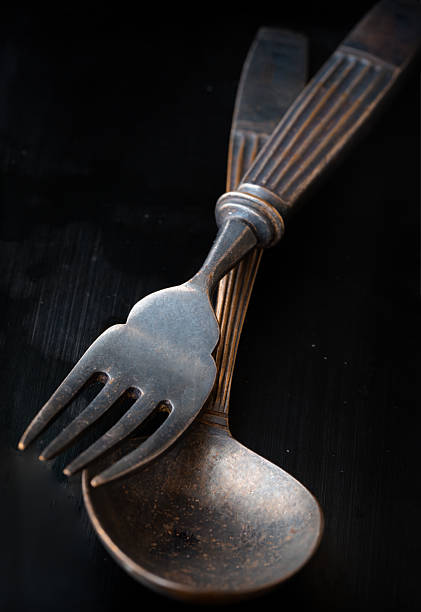 istock Ancient worn vintage cutlery on the black background. 2223859279