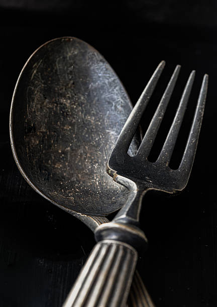 istock Ancient worn vintage cutlery on the black background. 2223859282