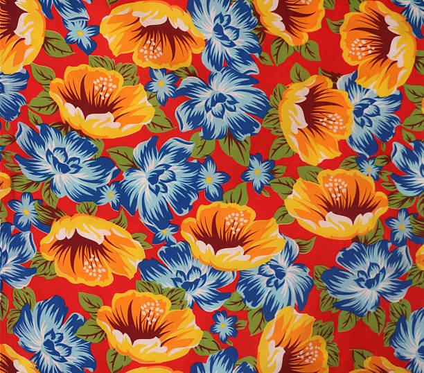 istock This is a vibrant, full-frame close-up of a floral fabric pattern featuring large orange and blue flowers with green leaves against a bright red background. 2223859291