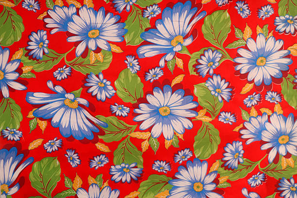 Antique floral fabric with clusters of pink, green and lavender flowers on a blue satin background..