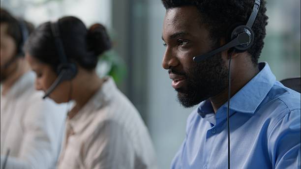 istock Call center helpline workers headset typing keyboard computer business service African American Indian Caucasian operators multiethnic three businesspeople help men woman online sale trading at office 2223860761