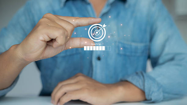 istock Businessman holding virtual target icon with loading progress bar, representing business goal setting, strategy development, and progress tracking. 2223863009