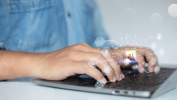 istock Man typing on a laptop with a glowing Artificial Intelligence (AI) processor chip hologram. Concept of machine learning, big data, and futuristic business process automation. 2223863025