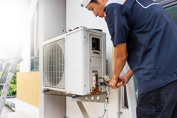 istock HVAC Technician Servicing Outdoor Air Conditioner Unit, Professional Repairing or Installing Residential AC System, Man Working on Air Conditioning Unit on Building Exterior 2223864316