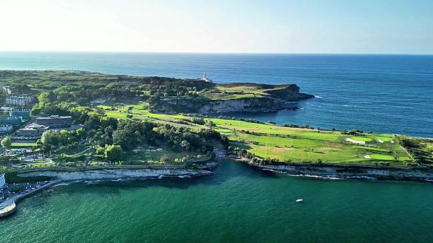 istock A stunning aerial view showcasing a beautiful coastal golf course alongside a lighthouse 2223872906