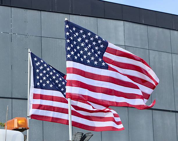 istock Two American Flags On A Parading Truck 2223874011