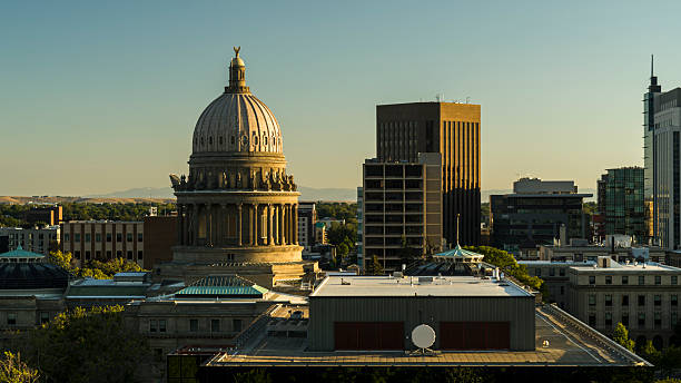 istock Golden hour illuminates Idaho State Capitol dome. Modern office buildings frame historic structure in Boise, Idaho. 2223877397