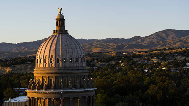istock Sandstone neoclassical Idaho State Capitol building against mountain backdrop. Afternoon light illuminates dome in Boise, Idaho. 2223877559