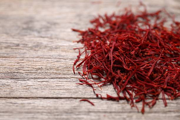 istock Aromatic saffron on wooden table, closeup. Space for text 2223877569
