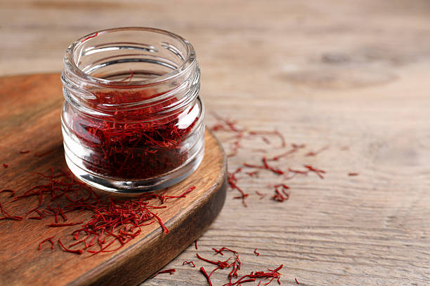 istock Aromatic saffron in glass jar on table, space for text 2223877620