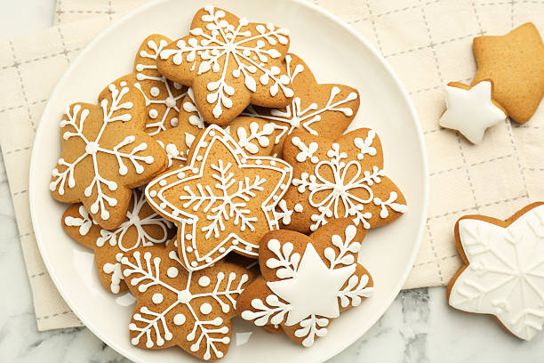 istock Tasty star shaped Christmas cookies with icing on white marble table, top view 2223878046
