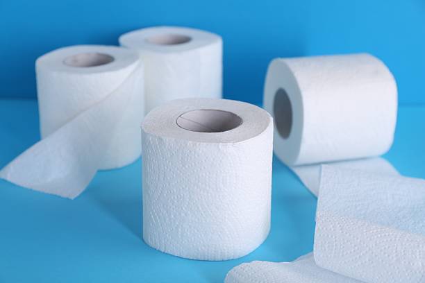 istock Soft toilet paper rolls on light blue background, closeup 2223878509