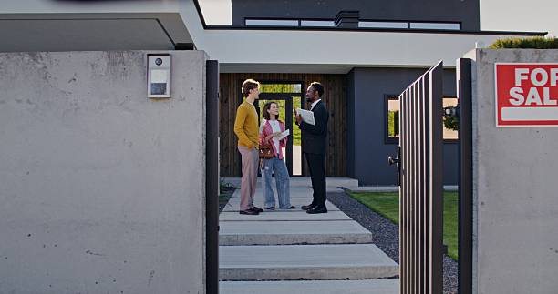 istock A real estate agent talks to clients 2223880595