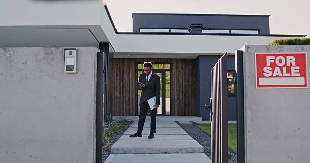 istock The real estate agent is talking on a mobile phone 2223880623