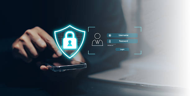 istock Cybersecurity login and data protection concept: A user's hands type on a laptop keyboard, with a glowing shield icon containing a padlock and a virtual login form for username and password. This image signifies secure access, online authentication. 2223881796