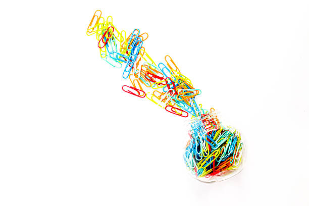 Colored paper clips on white background.