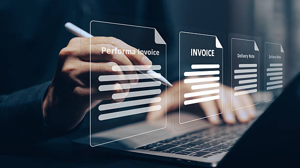 istock Digital Invoice Management: A hand uses a stylus to interact with glowing virtual invoices on a tablet/laptop screen, symbolizing efficient paperless transactions, online billing, and modern business finance. 2223882067