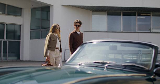 A man and a woman get into a car