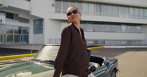 istock A woman poses standing near a car 2223882555